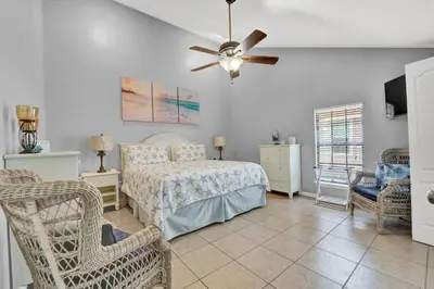 a bedroom with a bed and a ceiling fan at 2 BR townhome w/private patio, beach access, 4 communal pools, hot tub, mini golf, tennis, & more! in Panama City Beach