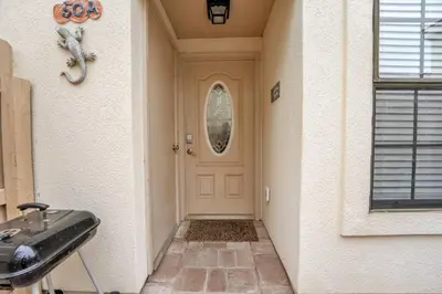 a front door of a home with aoice at 2 BR townhome w/private patio, beach access, 4 communal pools, hot tub, mini golf, tennis, & more! in Panama City Beach
