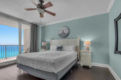 a bedroom with a bed with a view of the ocean at Majestic Beach Towers 1-1302 in Panama City Beach