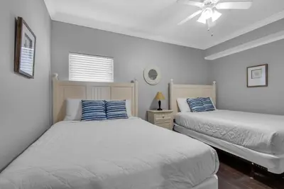 a bedroom with two beds and a ceiling fan at Majestic Beach Towers 1-1302 in Panama City Beach