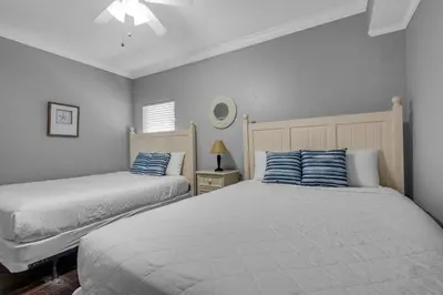 a bedroom with two beds with blue and white pillows at Majestic Beach Towers 1-1302 in Panama City Beach