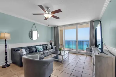 a living room with a couch and a view of the ocean at Majestic Beach Towers 1-1302 in Panama City Beach