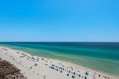 a beach with a lot of people and the ocean at Majestic Beach Towers 1-1302 in Panama City Beach