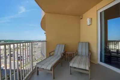 two chairs on a balcony with a view at Calypso 3-708 in Panama City Beach