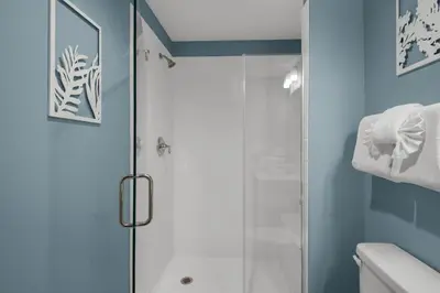 a bathroom with a shower with a glass door at Calypso 3-708 in Panama City Beach