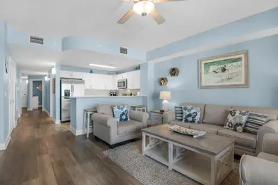 a living room with a couch and a table at Calypso 3-708 in Panama City Beach