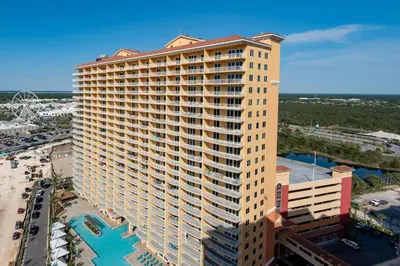 an aerial view of a tall building with a pool at Calypso 3-708 in Panama City Beach