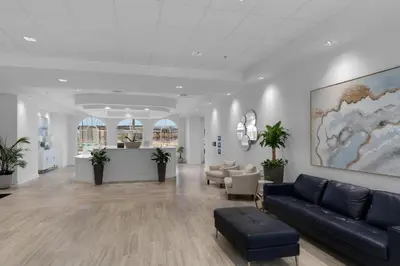 a lobby with a couch and chairs in a building at Calypso 3-708 in Panama City Beach