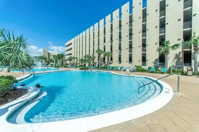 a swimming pool in front of a building at Emerald Beach 1036 - Turquoise Turtle in Panama City Beach