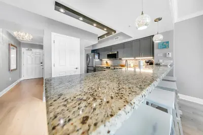 a kitchen with a large marble counter top at Emerald Beach 1036 - Turquoise Turtle in Panama City Beach