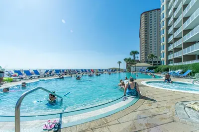 a pool at a resort with people in the water at Emerald Beach 1036 - Turquoise Turtle in Panama City Beach