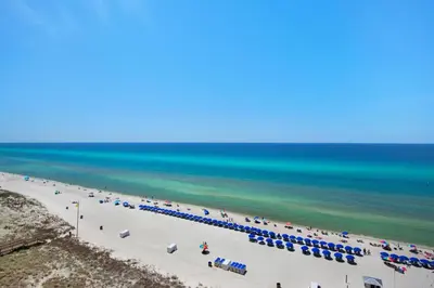 an overhead view of a beach with umbrellas and the ocean at Emerald Beach 1036 - Turquoise Turtle in Panama City Beach