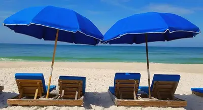 a group of chairs and umbrellas on a beach at Top of the Gulf 808- Gulf Coast Getaway in Panama City Beach
