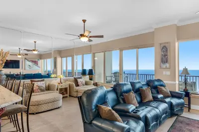a living room with a blue leather couch and chairs at Hidden Dunes 1803 in Panama City Beach