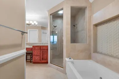 a bathroom with a tub and a shower and a sink at Hidden Dunes 1803 in Panama City Beach