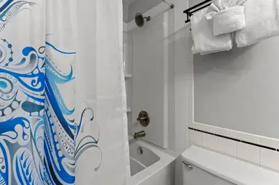 a bathroom with a shower curtain and a toilet at Top of The Gulf 306 in Panama City Beach