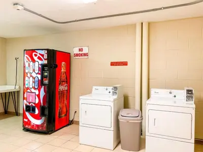 a soda machine in a room with two washing machines at Top of The Gulf 306 in Panama City Beach