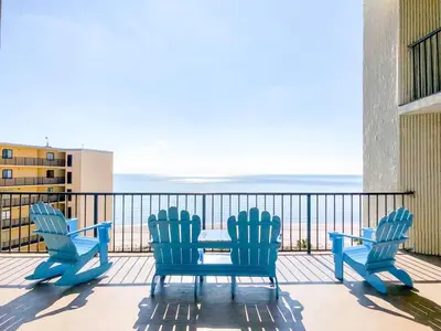 two chairs and a table on a balcony with the ocean at Top of The Gulf 306 in Panama City Beach