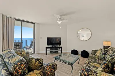 a living room with a couch and a tv at Aquavista 804E in Panama City Beach