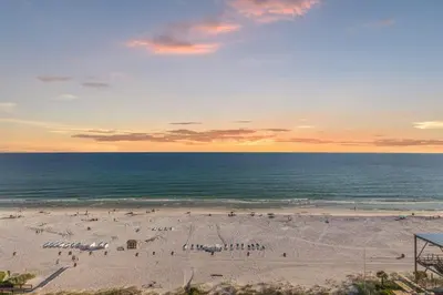 a beach with a group of people and the ocean at The Summit 1305 in Panama City Beach