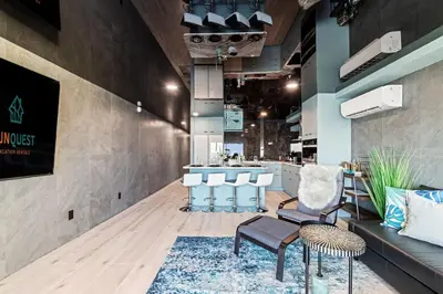 a lobby with a bar with chairs and a couch at The Summit 1305 in Panama City Beach