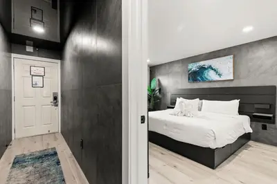 a bedroom with a large white bed and a door at The Summit 1305 in Panama City Beach
