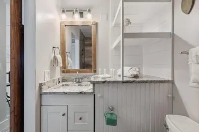 a white bathroom with a sink and a mirror at Top Of The Gulf 704 in Panama City Beach