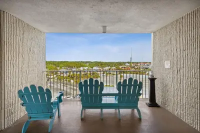 two chairs and a table on a balcony with a view at Top Of The Gulf 704 in Panama City Beach