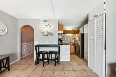 a kitchen with a table and chairs in a room at The Summit 817 in Panama City Beach