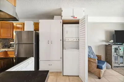 a kitchen with white cabinets and a refrigerator at The Summit 817 in Panama City Beach