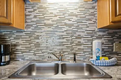 a kitchen counter with a sink and a brick wall at The Summit 817 in Panama City Beach