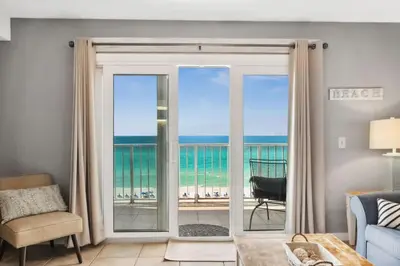 a living room with a view of the ocean at The Summit 817 in Panama City Beach