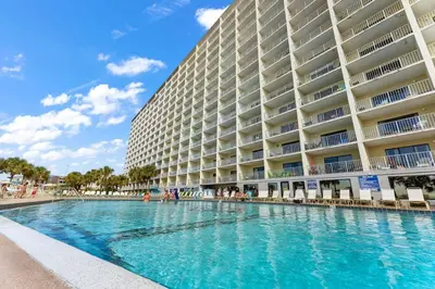 a swimming pool in front of a large building at The Summit 712 in Panama City Beach