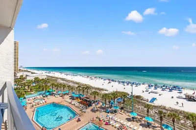 a view of the beach from the balcony of a resort at The Summit 712 in Panama City Beach