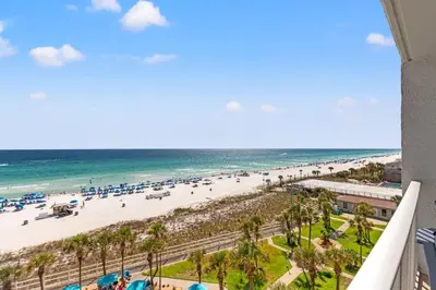 a view of the beach from the balcony of a resort at The Summit 712 in Panama City Beach