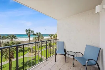 a balcony with two chairs and a view of the beach at The Summit 307 in Panama City Beach
