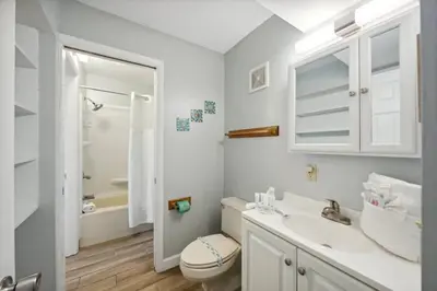 a white bathroom with a toilet and a sink at The Summit 307 in Panama City Beach