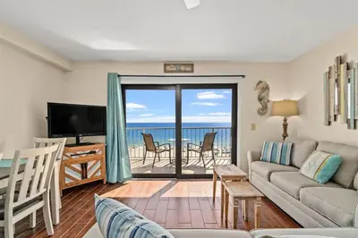 a living room with a couch and a view of the ocean at The Summit 731 in Panama City Beach