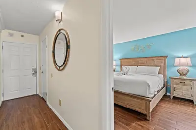 a bedroom with a large bed and a mirror at The Summit 731 in Panama City Beach