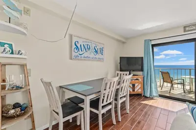 a dining room with a table and chairs and a view of the ocean at The Summit 731 in Panama City Beach