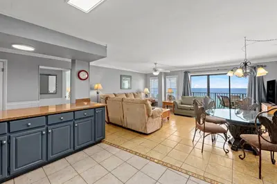 a kitchen and living room with a table and a dining room at The Summit 1503 in Panama City Beach