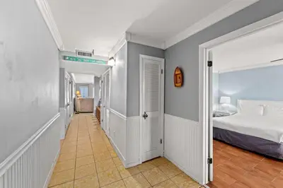 a bedroom with a bed and a hallway at The Summit 1503 in Panama City Beach