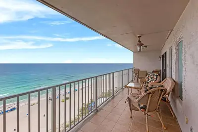 a balcony with chairs and a view of the beach at The Summit 1503 in Panama City Beach