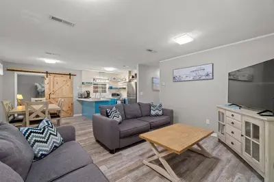 a living room with a couch and a flat screen tv at Paradise Found in Panama City Beach