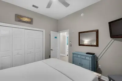 a bedroom with a bed and a mirror and a tv at 30A-SEA For Yourself - Seagrove Highlands in Santa Rosa Beach