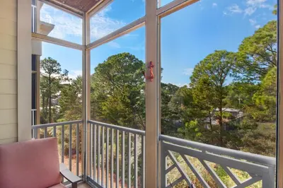 a screened in porch with a view of the woods at 30A-SEA For Yourself - Seagrove Highlands in Santa Rosa Beach