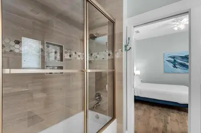 a shower with a glass door in a bathroom at Bless My Sol in Santa Rosa Beach
