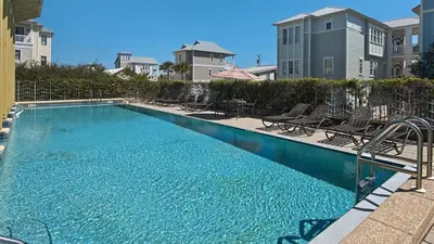 a large swimming pool with chairs at Bless My Sol in Santa Rosa Beach
