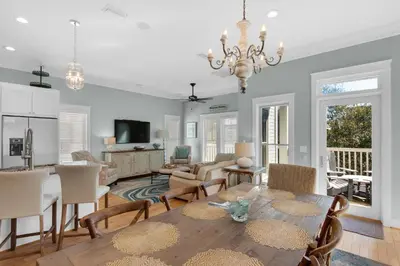 a dining room and living room with a table and chairs at Bless My Sol in Santa Rosa Beach