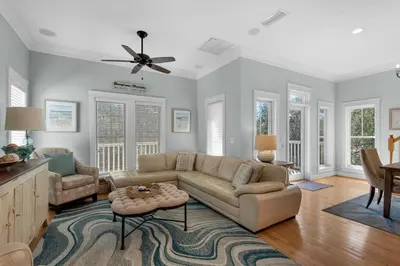 a living room with a couch and a table at Bless My Sol in Santa Rosa Beach